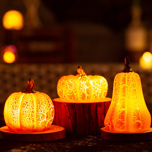 Glowing pumpkin candles grouped on black lace webbing