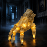 Skeleton hand crawling across the floorboards of a dark hallway